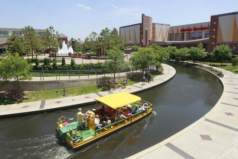 A water taxi navigates the Bricktown Canal in the Bricktown area of Oklahoma City.