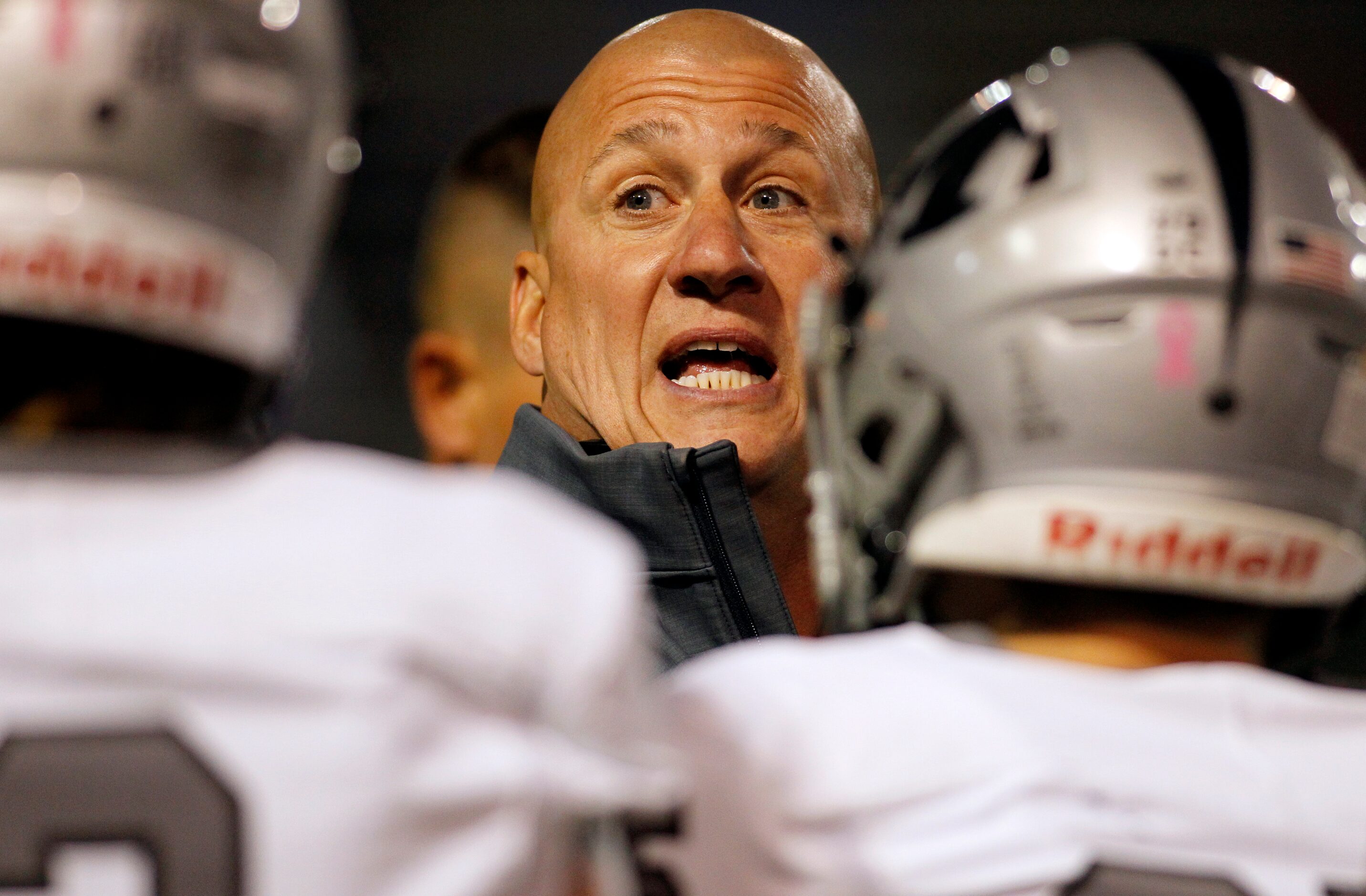 Arlington Martin head coach Bob Wager shares wisdom with his players prior to the opening...