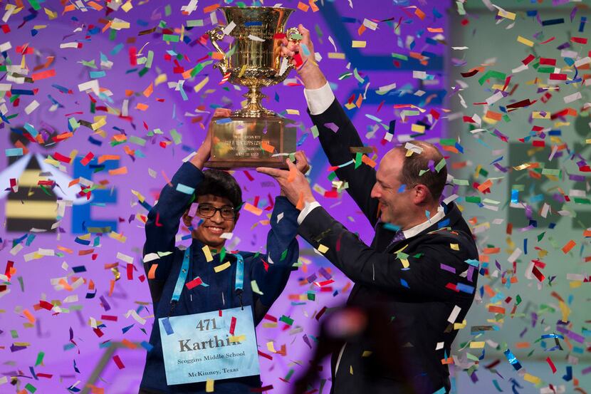 Karthik Nemmani, 14, from McKinney, Texas, is presented with the Scripps National Spelling...
