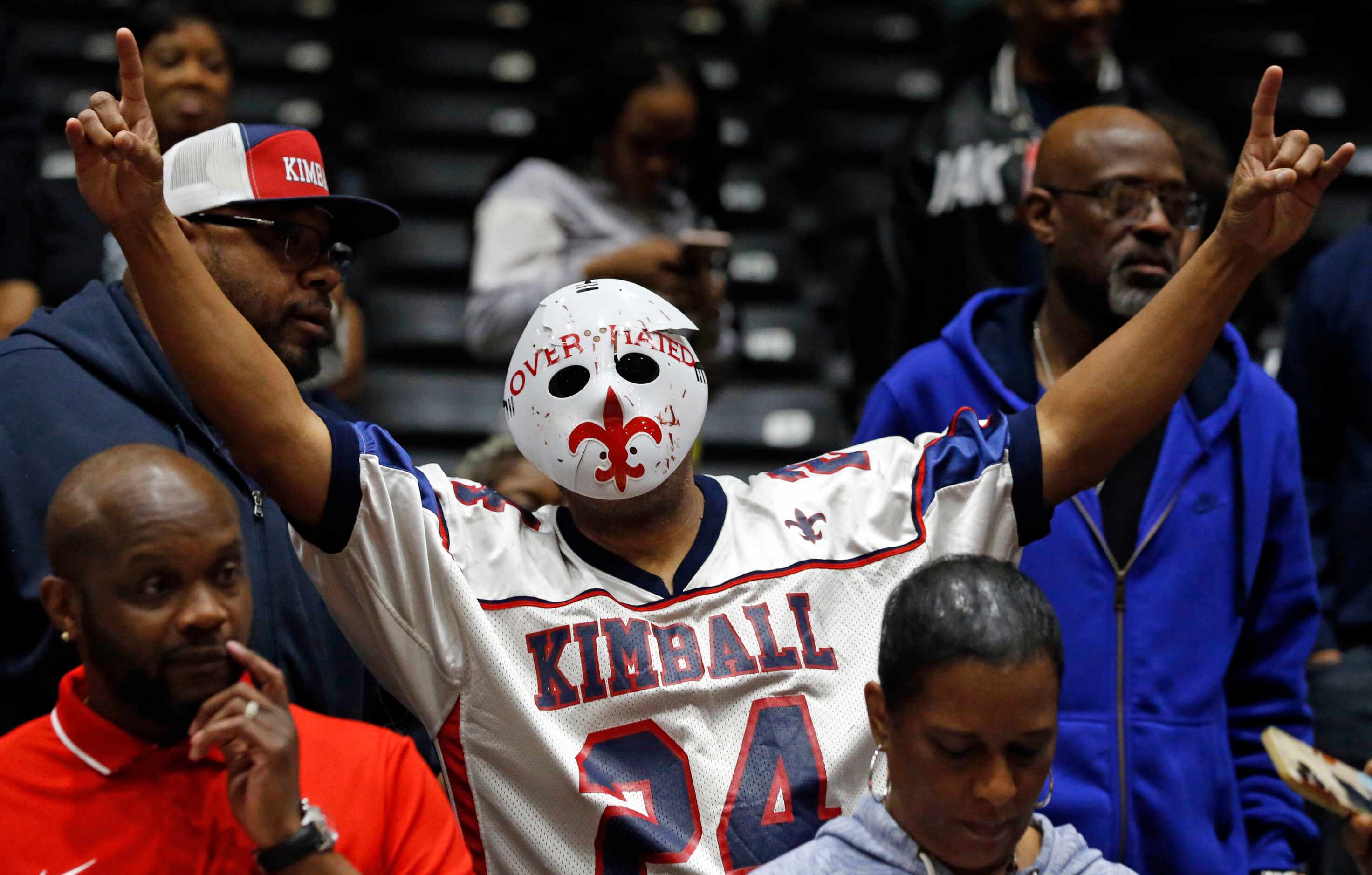 A Kimball high fan in a hockey mask signals the team’s victory over Lancaster high in the...