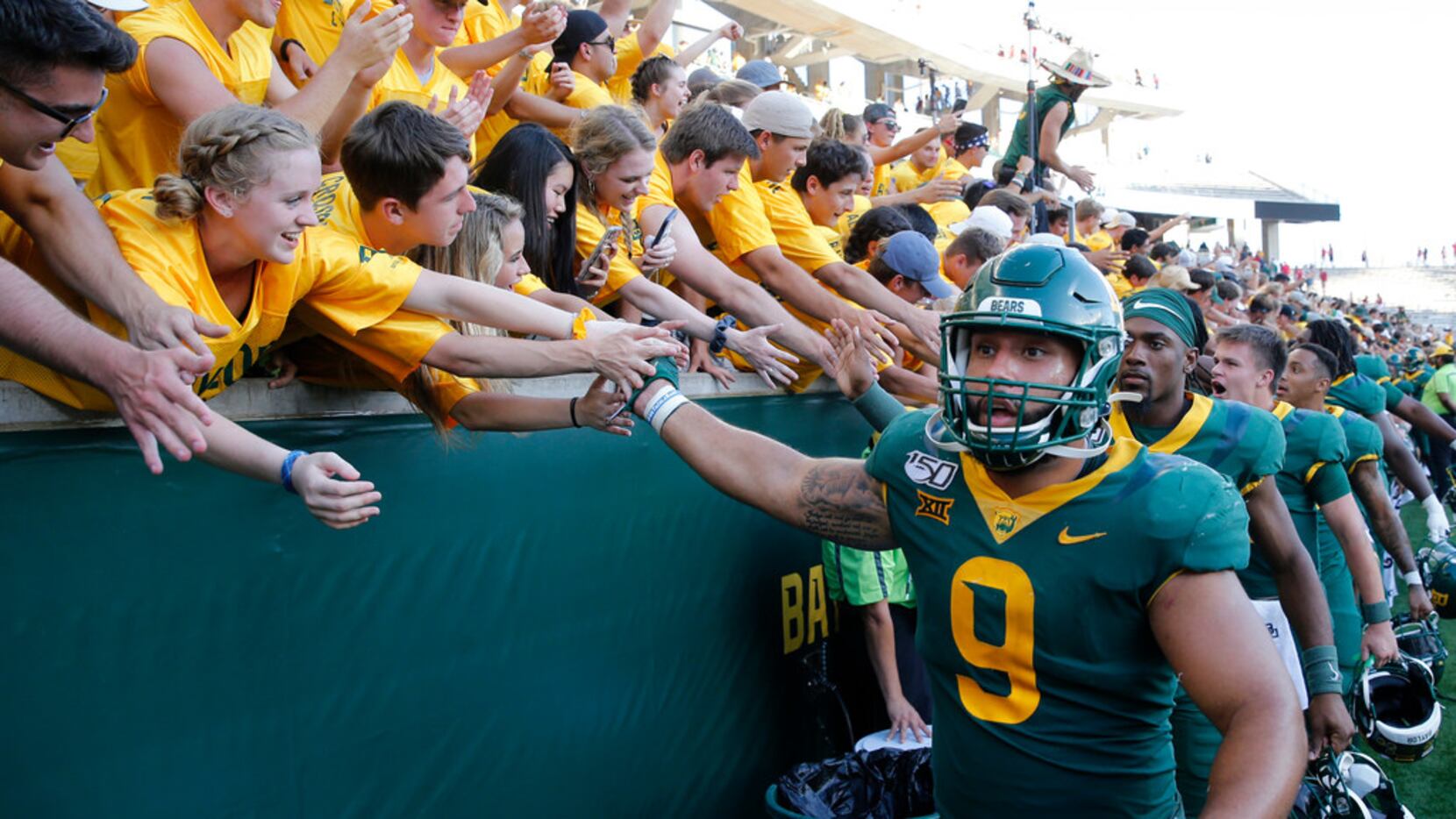 Baylor Bears defensive end James Lockhart (9) celebrates with fans after defeating the Iowa...