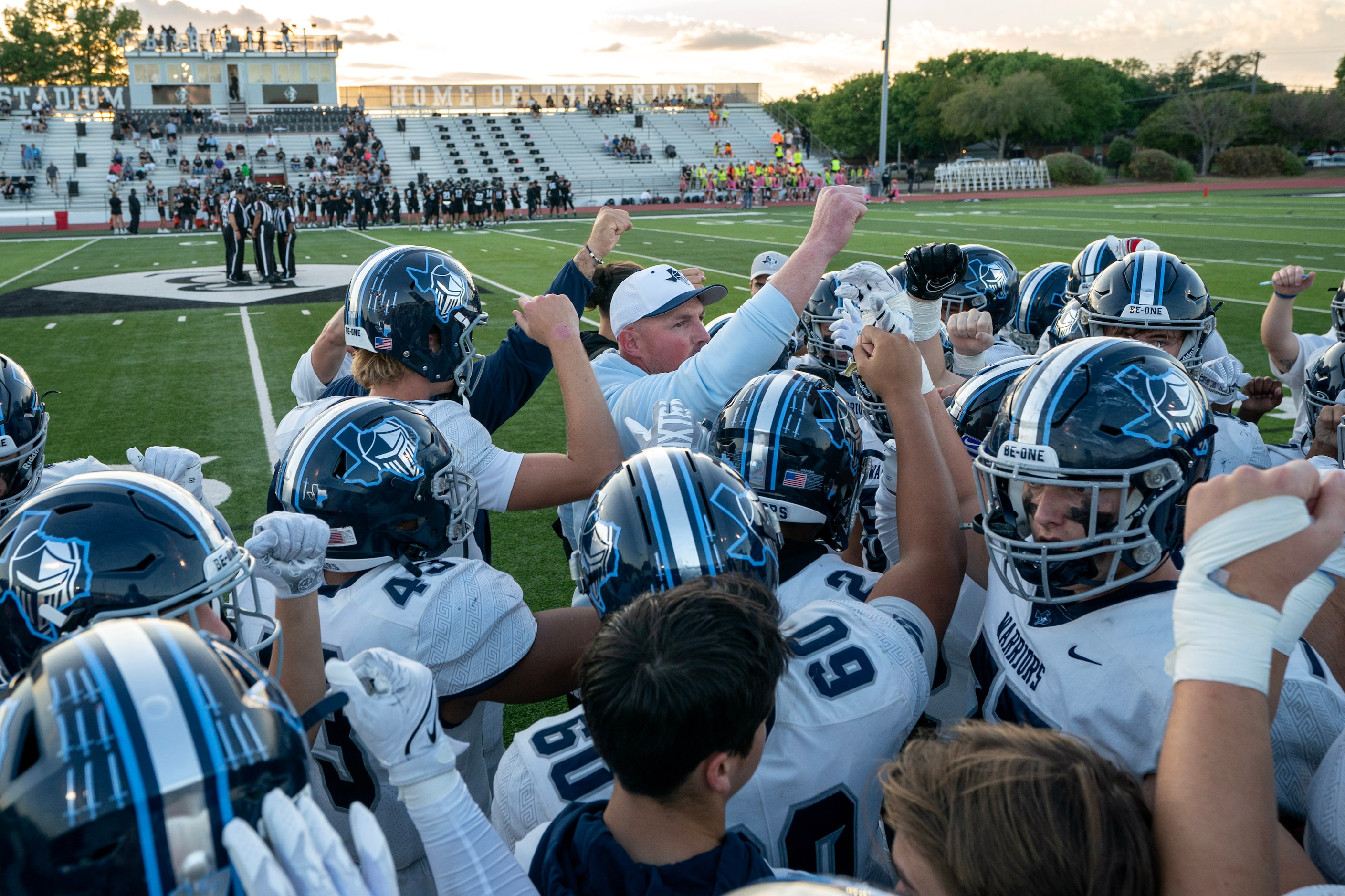 Former Dallas Cowboys great and Argyle Liberty Christian head coach Jason Witten huddles...