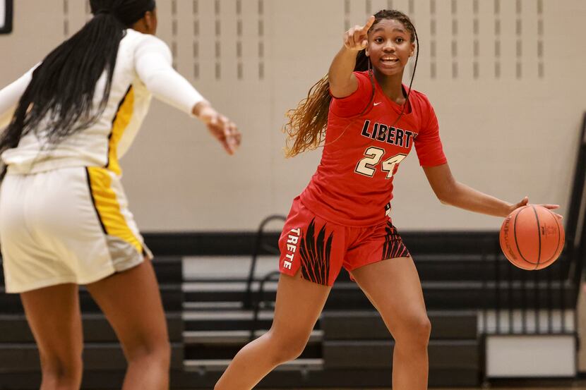 Frisco Liberty High School's Jacy Abii (24) dribbles the ball up the court during a game at...