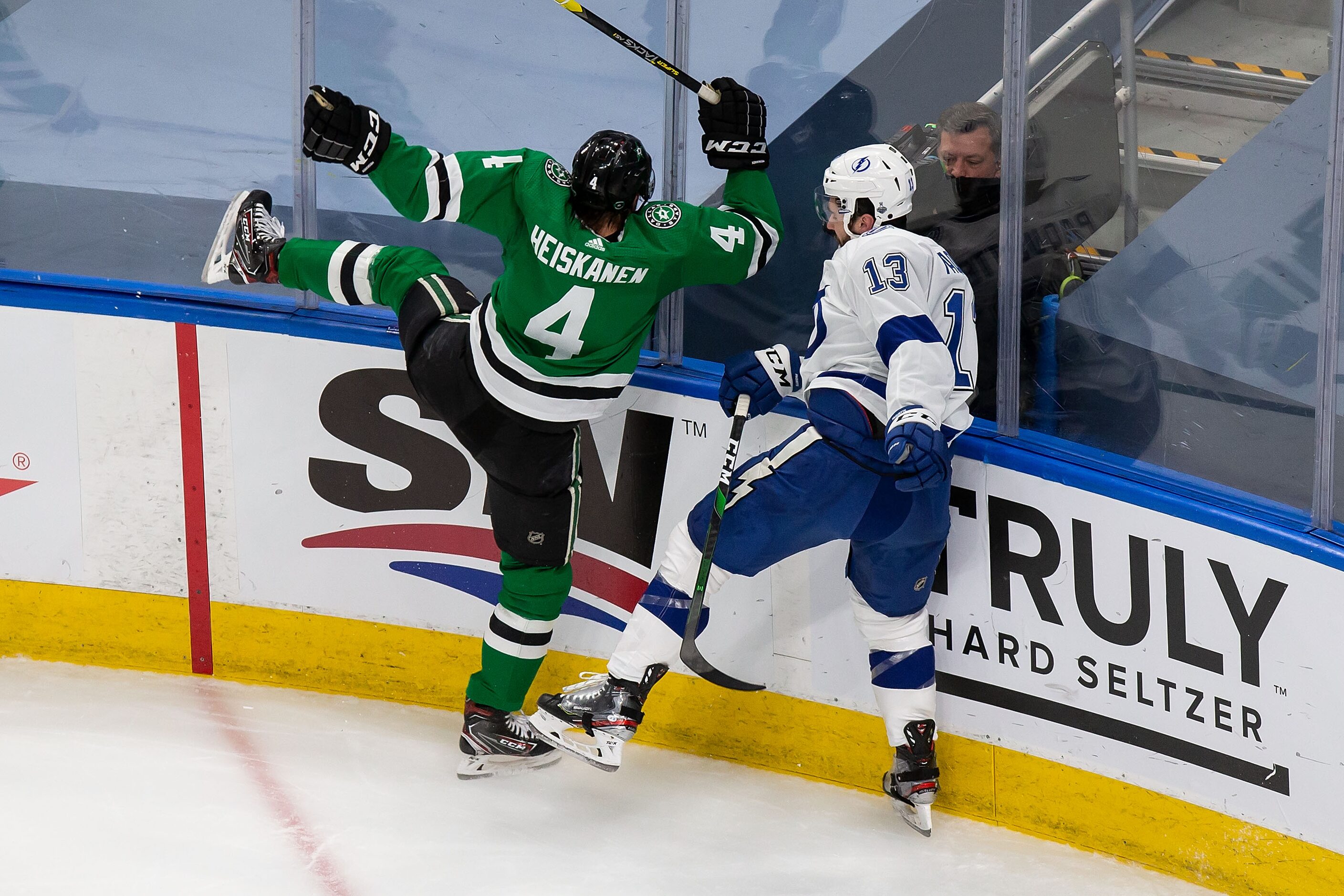 Miro Heiskanen (4) of the Dallas Stars collides with Cedric Paquette (13) of the Tampa Bay...