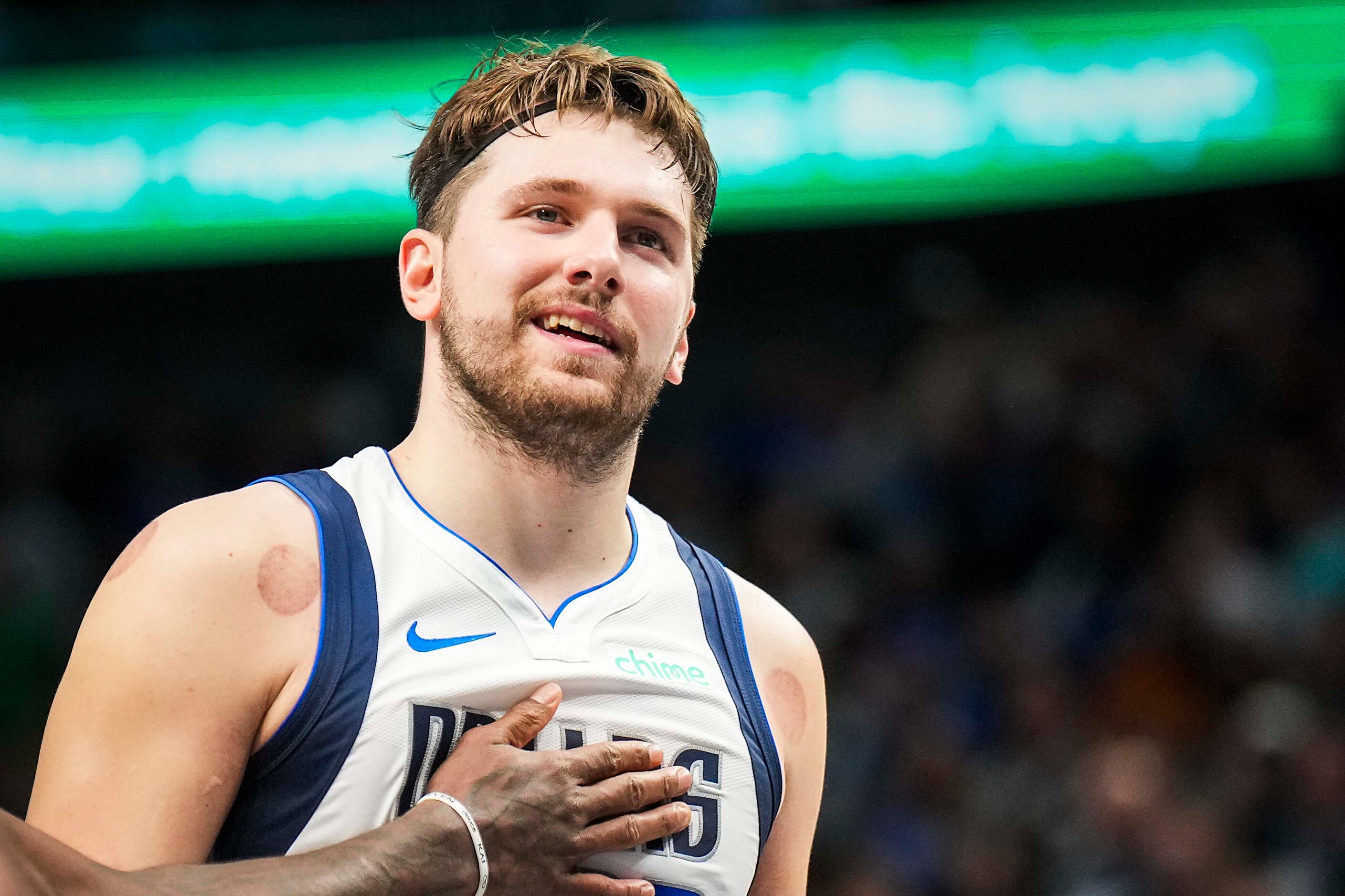 Dallas Mavericks guard Luka Doncic (77) gets a pat on the chest from guard Kyrie Irving...