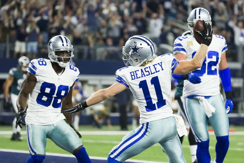 Dallas Cowboys wide receiver Cole Beasley (11) spikes the ball after scoring on a 5-yard...