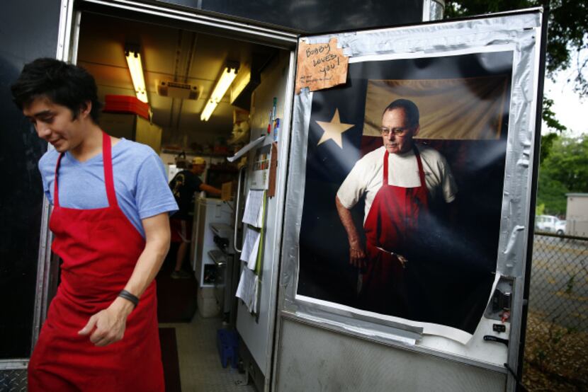 A large poster of the late  legendary pitmaster Bobby Mueller hangs on the back door to La...