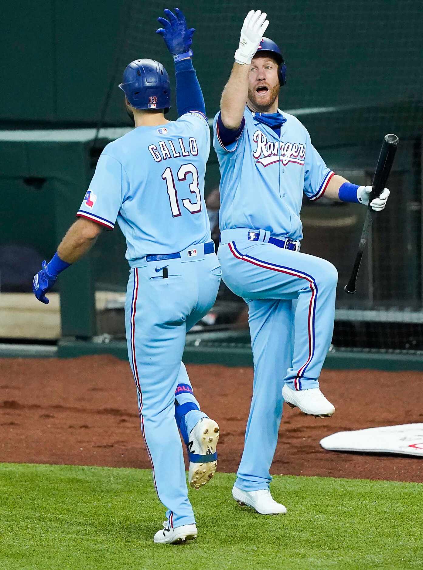 Texas Rangers outfielder Joey Gallo celebrates with third baseman Todd Frazier after hitting...