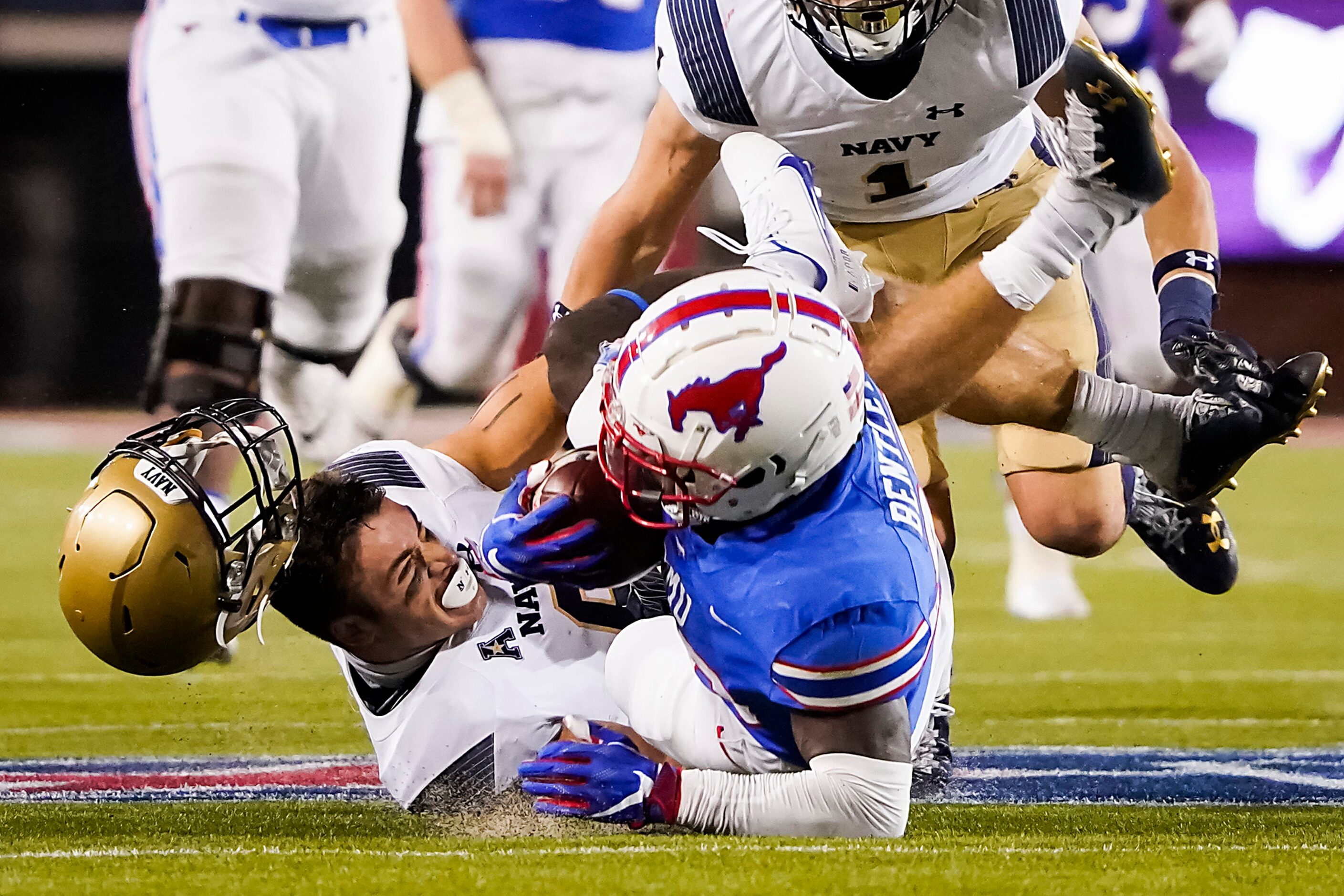 SMU running back Ulysses Bentley IV (26) is brought down by Navy defensive back Mitchell...