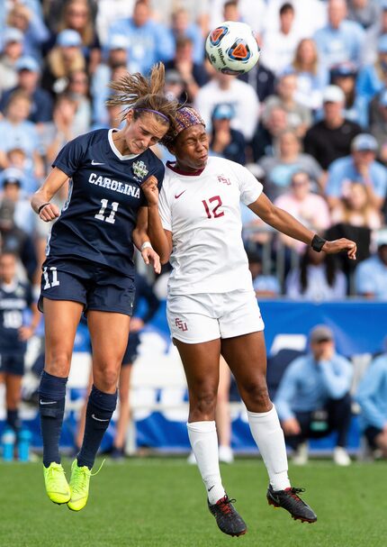 North Carolina's Emily Fox (11) and Florida State's Kaycie Tillman (12) jump for the ball...