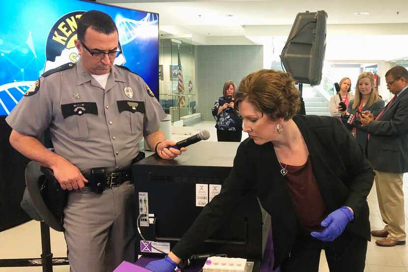 In this April 10, 2019, file photo, Regina Wells, foreground right, a forensic laboratories...