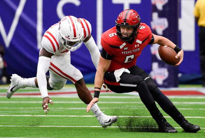 Texas Tech quarterback McLane Carter, right, escapes the tackle of Mississippi defensive end...