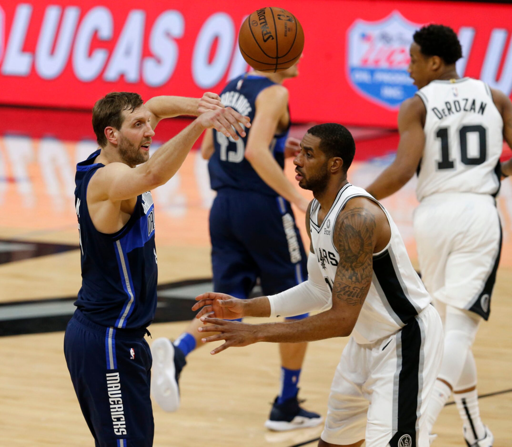 Dallas Mavericks forward Dirk Nowitzki (41) passes over San Antonio Spurs center LaMarcus...