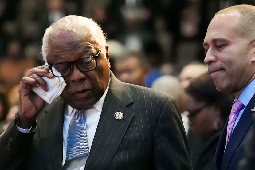 Rep. James Clyburn, D-SC, wipes a tear as he stands with House Minority Leader Hakeem...