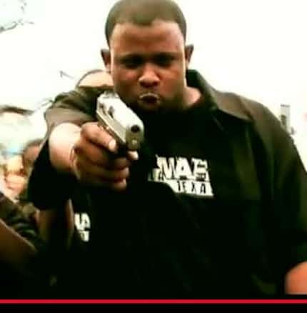 Jayson Moore points a handgun in one of his rap videos