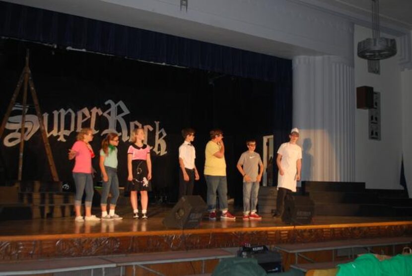 
J.L. Long Middle School choir students practice their roles during a dress rehearsal of...