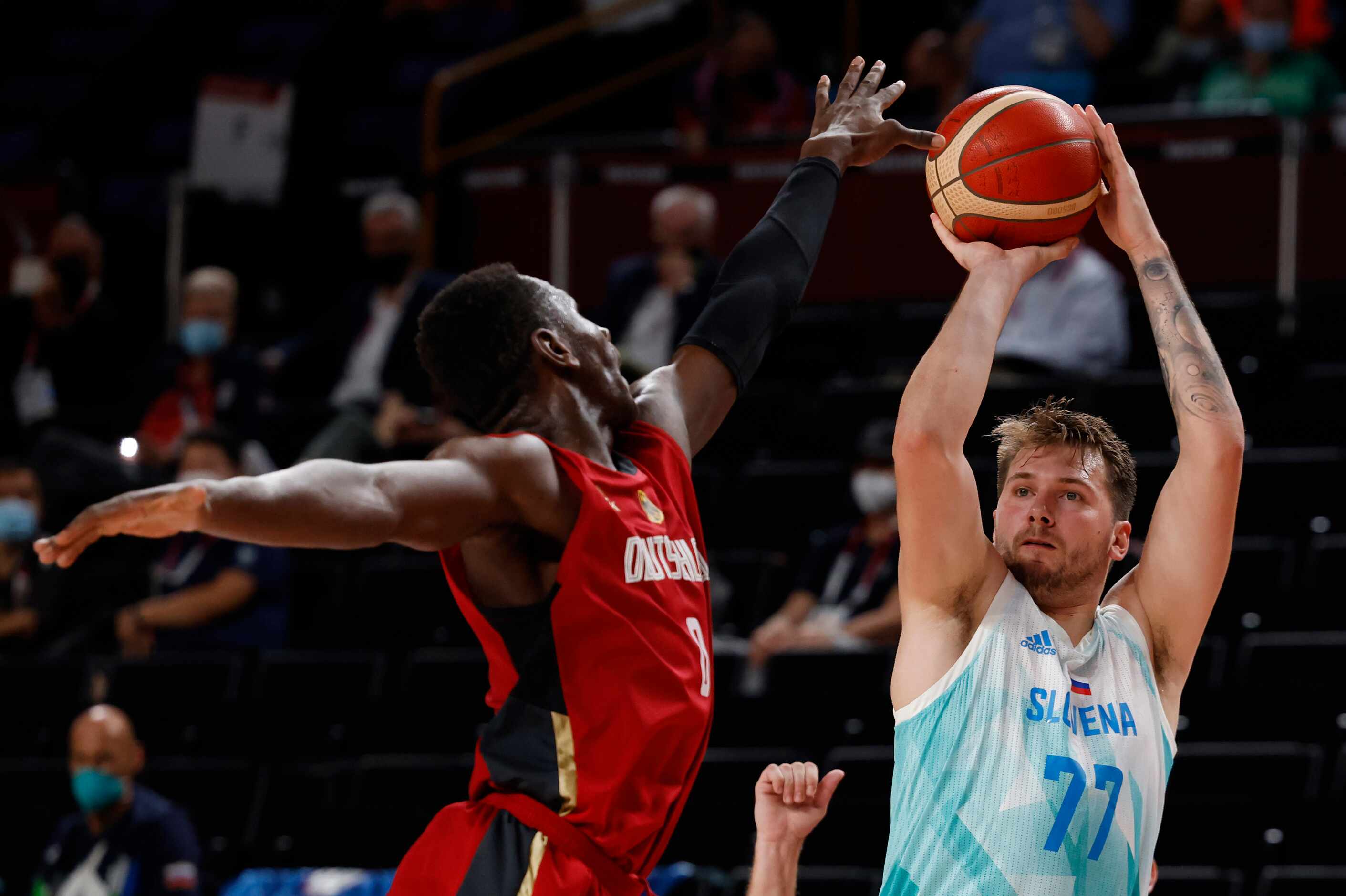 Slovenia’s Luka Doncic (77) shoots over Germany’s Isaac Bonga (0) during the second half of...