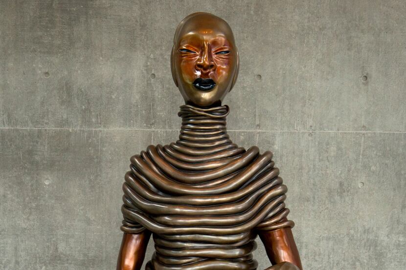 "The Seated III," a 7-foot-tall bronze figure by artist Wangechi Mutu, presides gracefully...