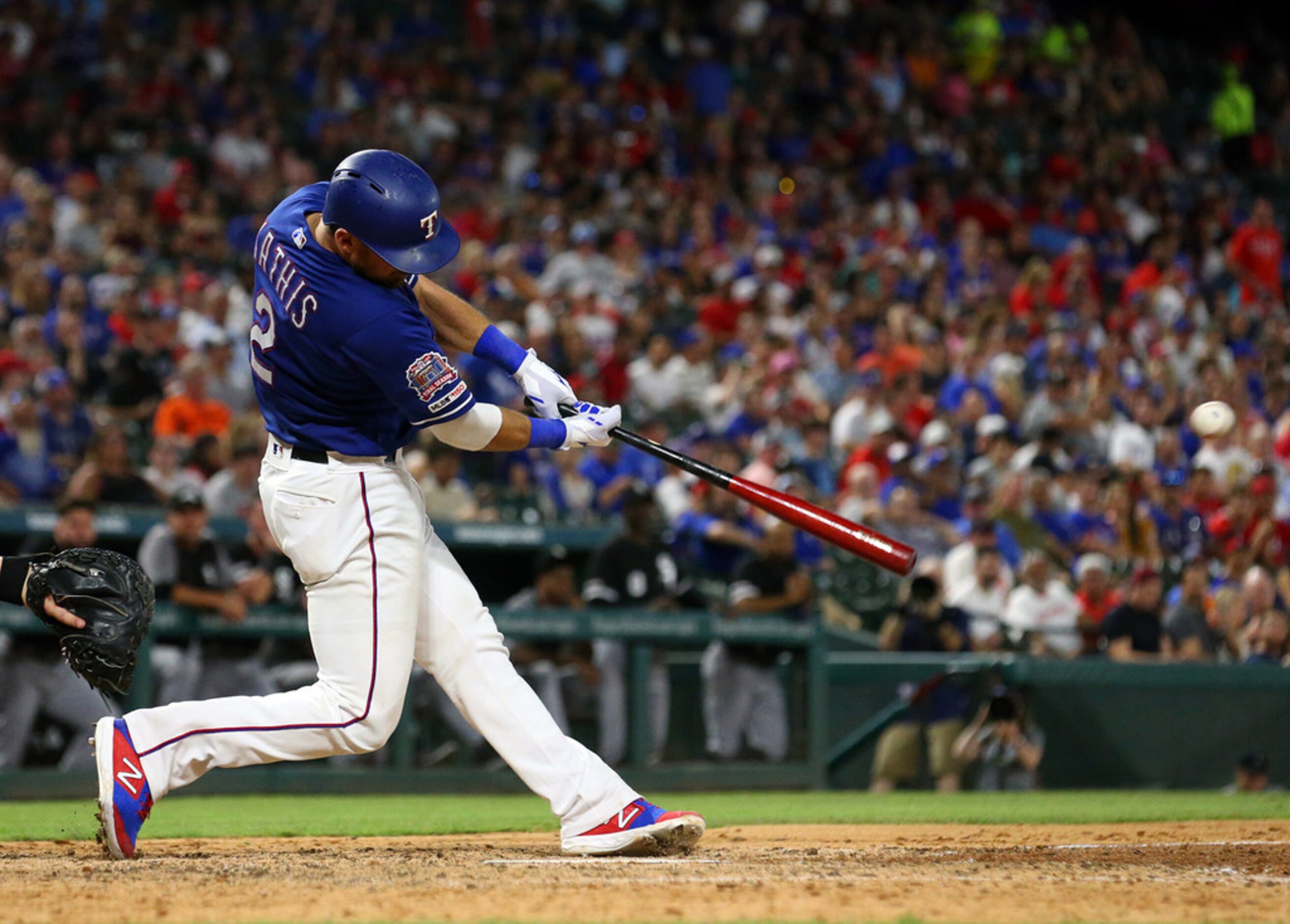 The Texas Rangers' Jeff Mathis hits a single in the sixth inning against the Chicago White...