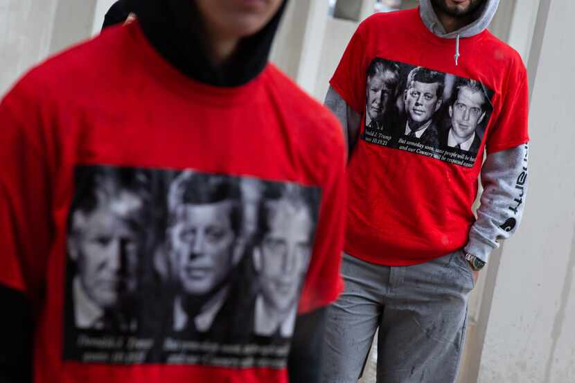 QAnon believers wear shirts with Donald Trump, John F. Kennedy, and John F. Kennedy Jr. at a...