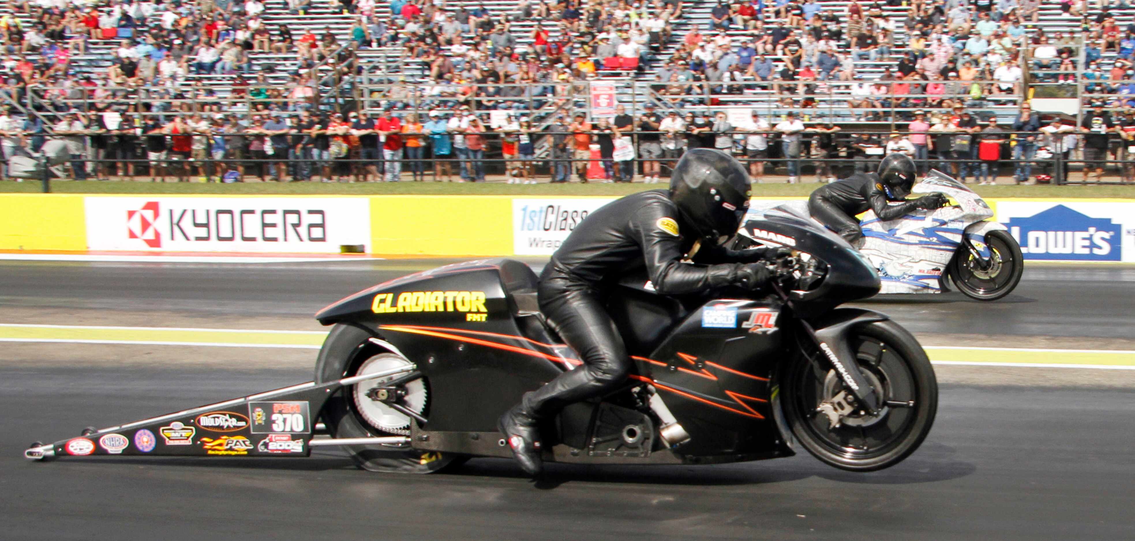 M. Ingwersen ( foreground) competes against J. Savoie (2) during the Pro Stock Motorcycle...