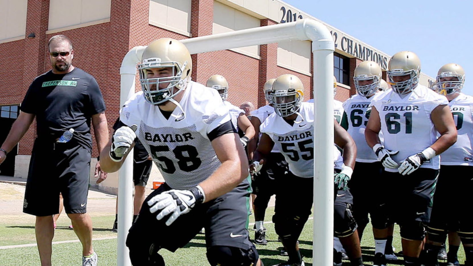 Baylor's Spencer Drango runs through a drill with the rest of the offensive line during the...