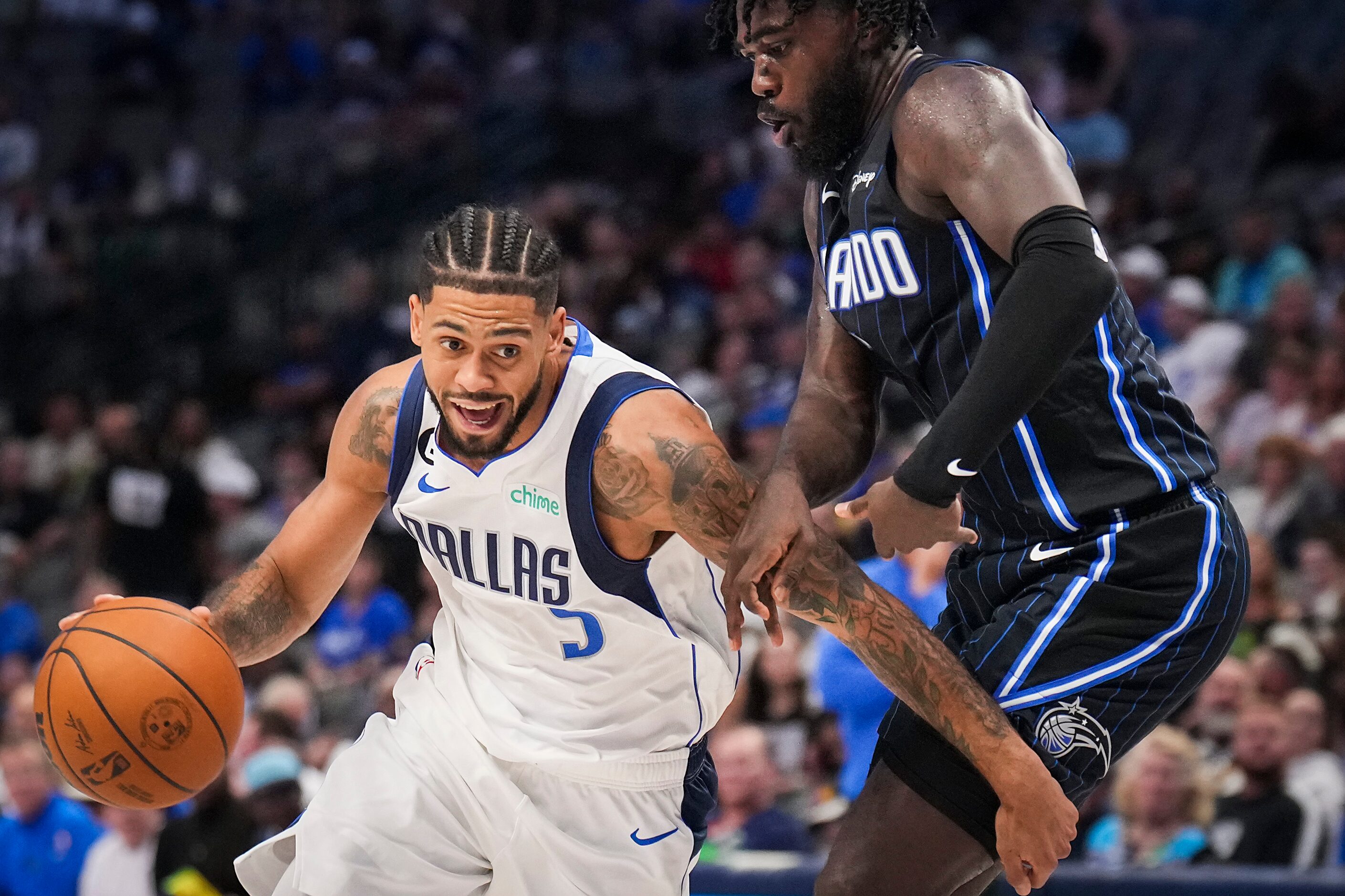 Dallas Mavericks guard Tyler Dorsey (5) drives against Orlando Magic guard Kevon Harris (7)...