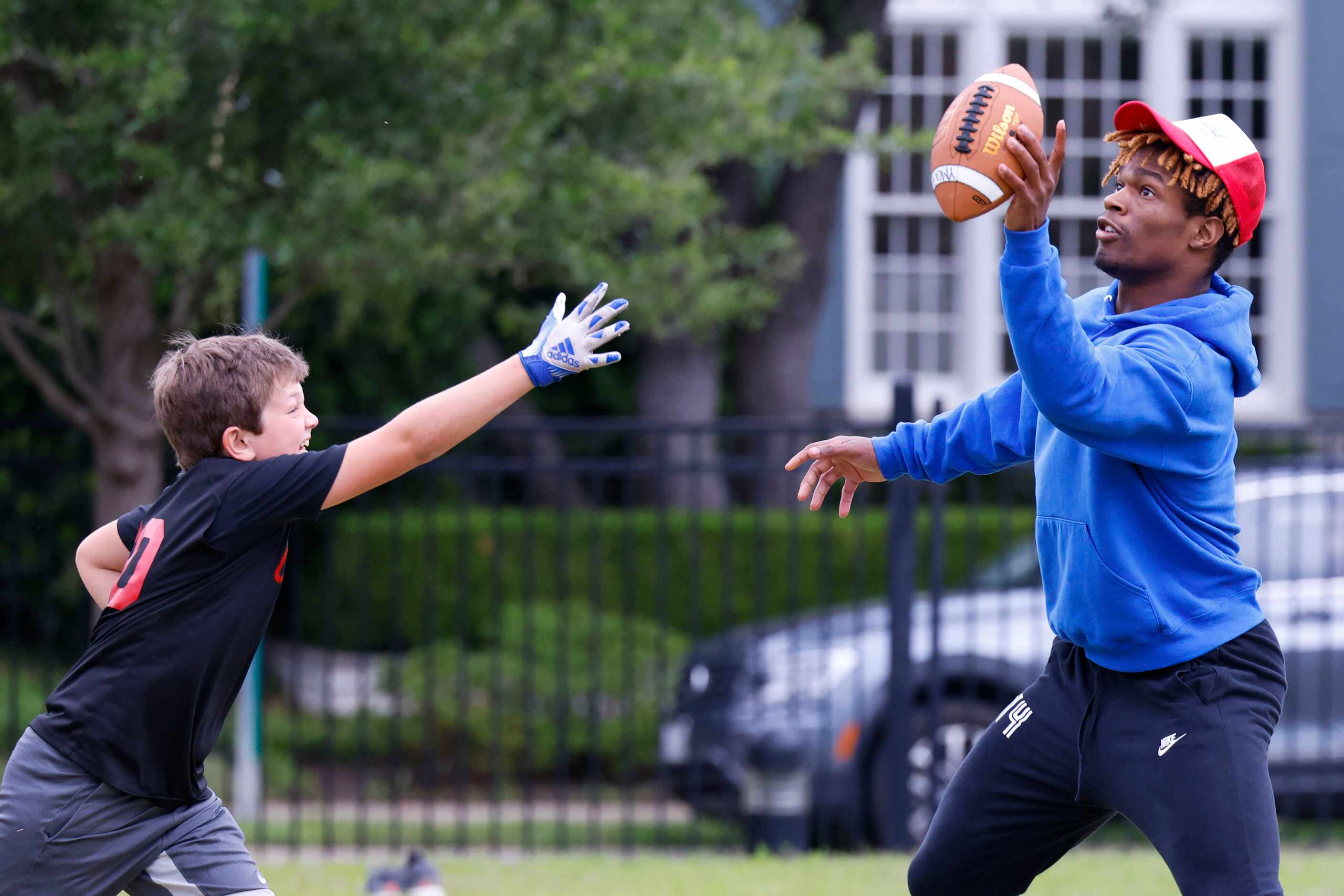 SMU’s Bryan Massey (right) catches the ball during a special session of football drills and...