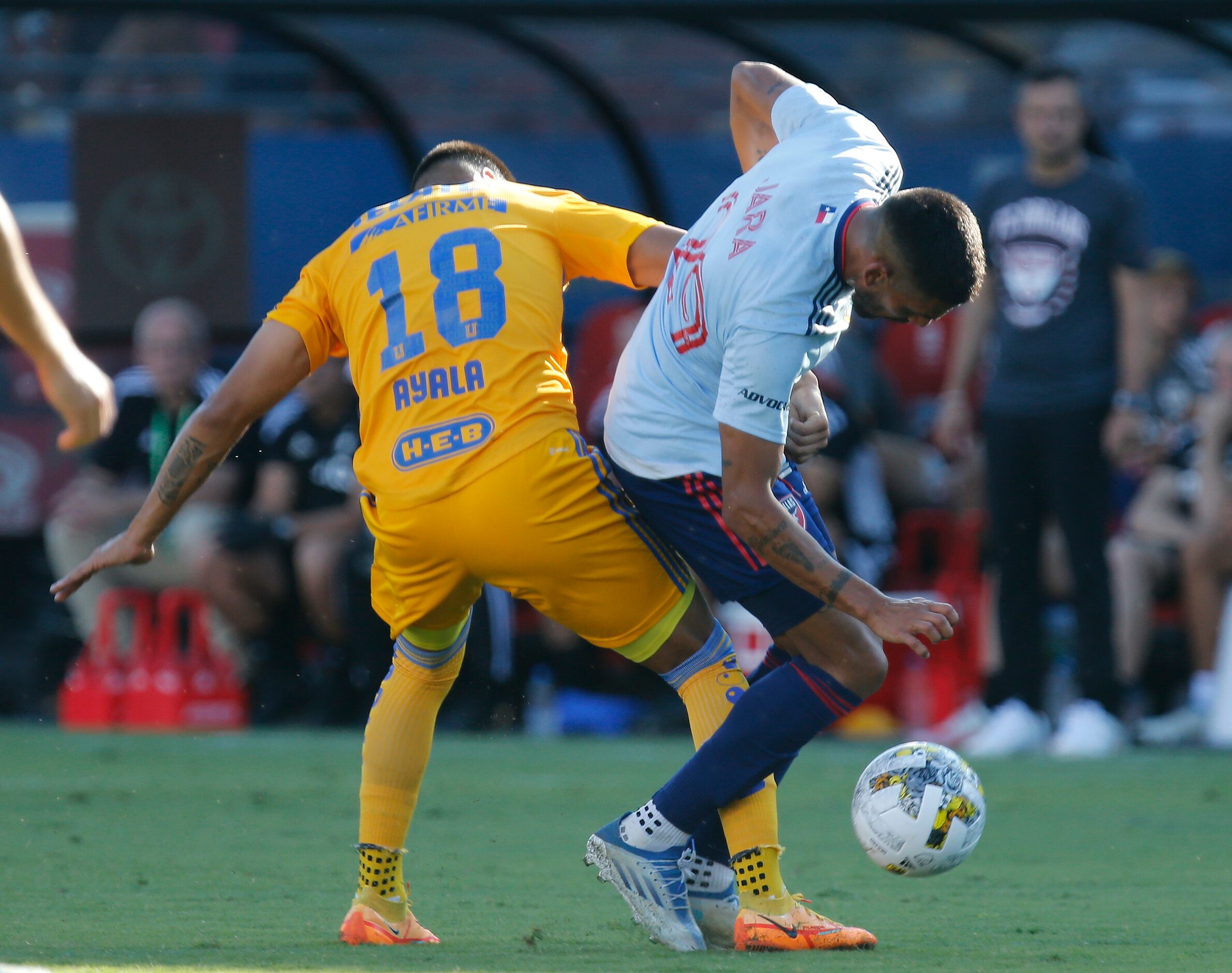 FC Dallas forward Franco Jara (29) gets bumped by Tigres UANL midfielder David Ayala (18)...