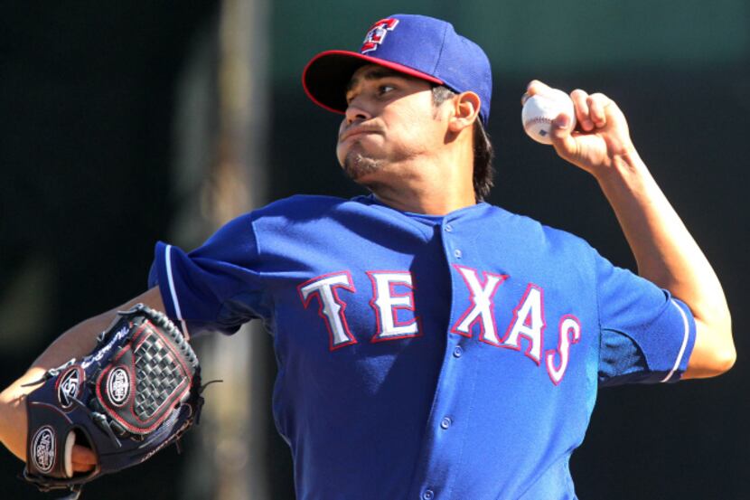 Texas pitcher Martin Perez throws a pitch during the intrasquad game  at the Texas Rangers...