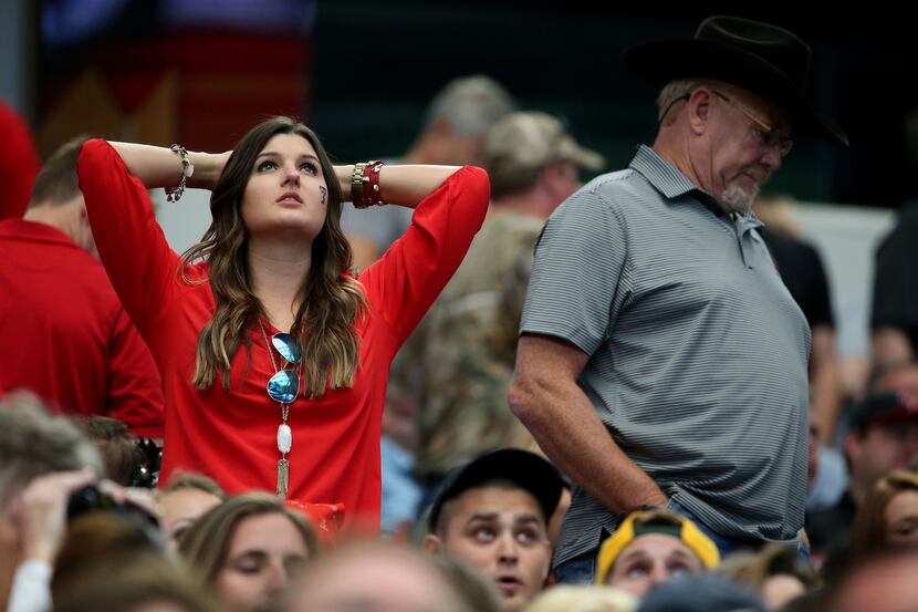 A Texas Tech Red Raiders fan reacts to a fumble call in the first half during an NCAA...
