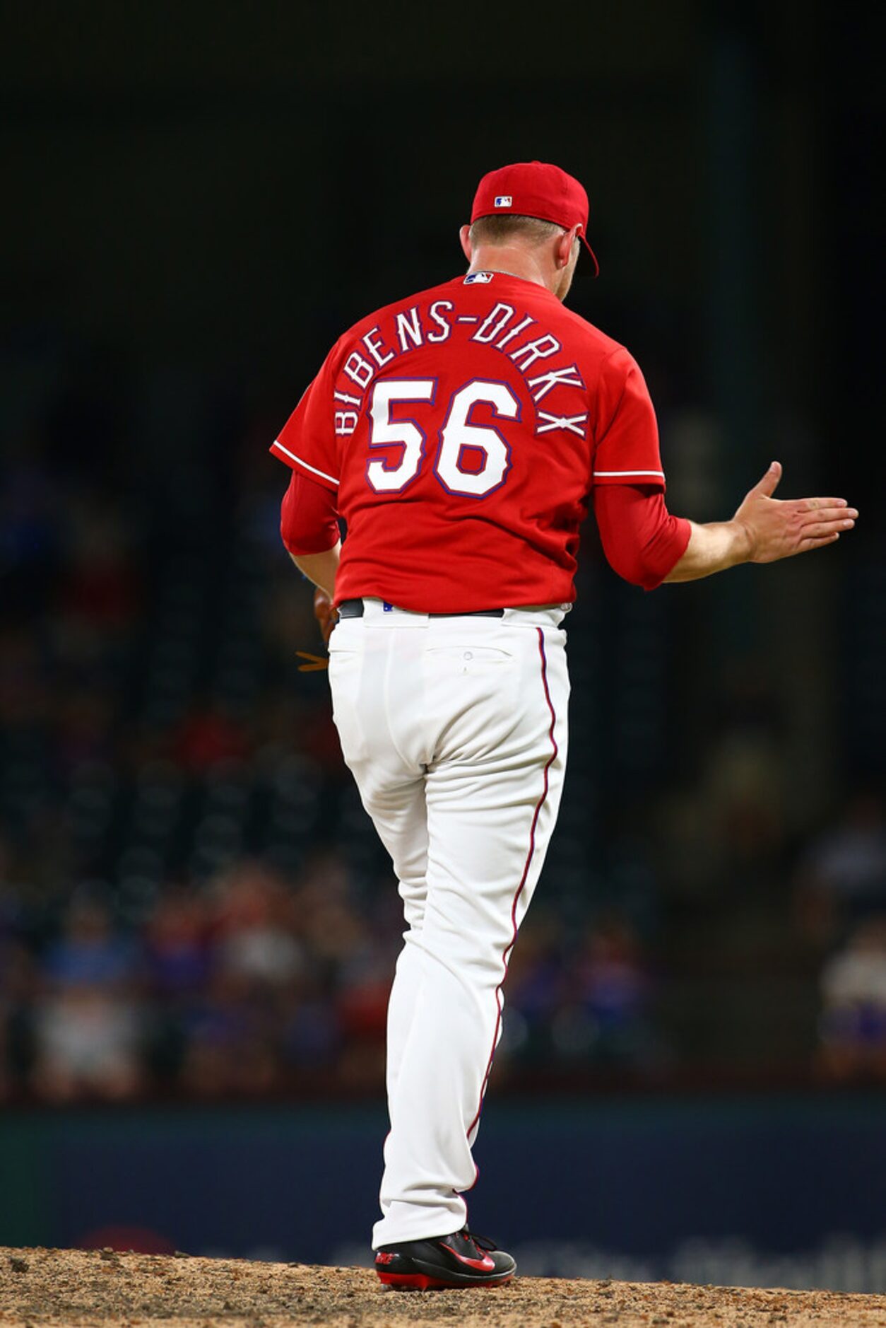 ARLINGTON, TX - AUGUST 03: Austin Bibens-Dirkx #56 of the Texas Rangers reacts after...