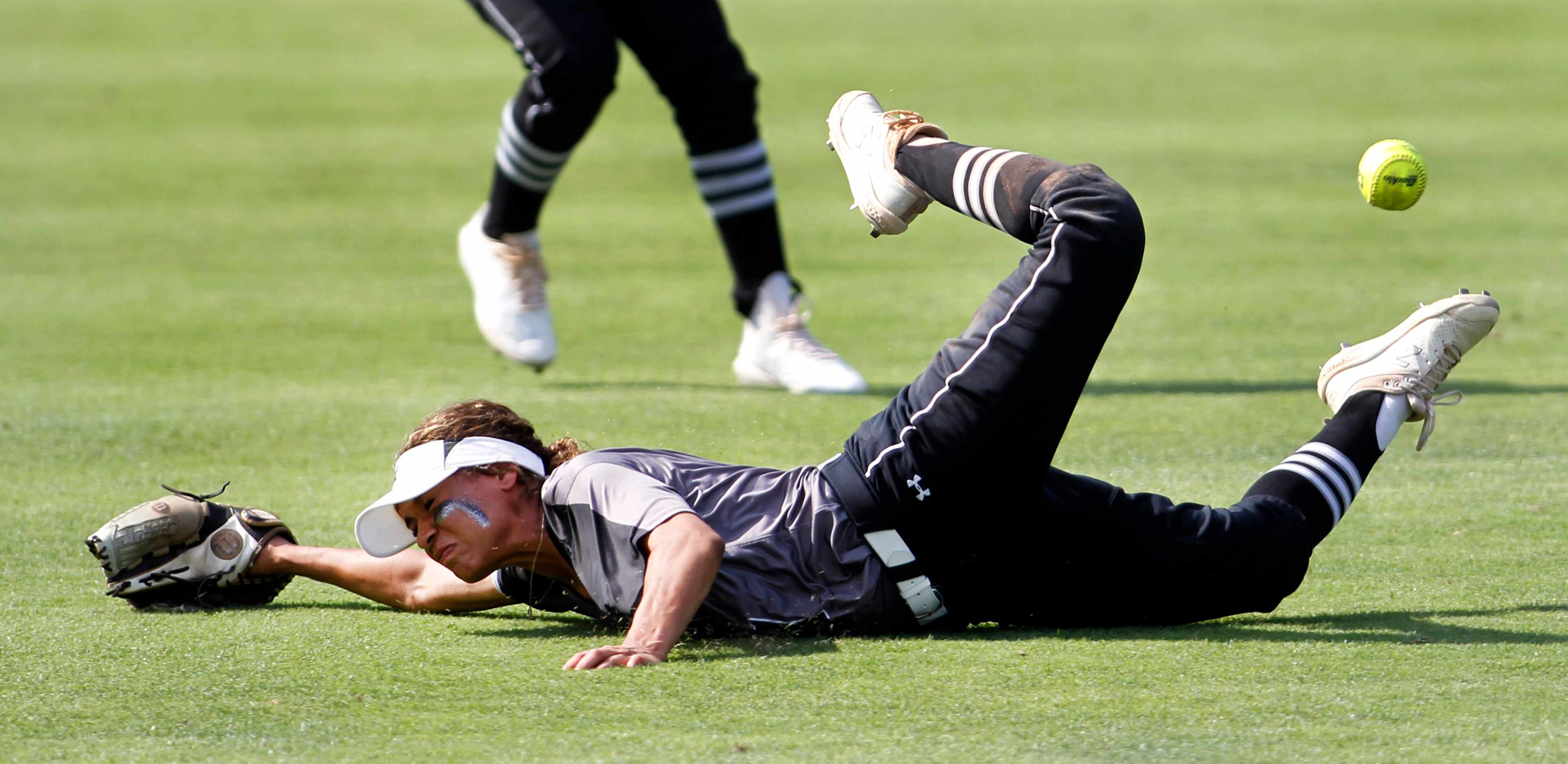 Denton Guyer center fielder Tehya Pitts (7) makes a diving attempt at a line drive from a...