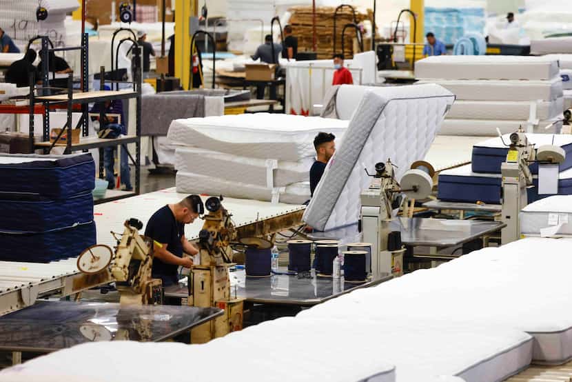 Workers work preparing and packaging mattresses on, Tuesday, March 12, 2024, at Milton...