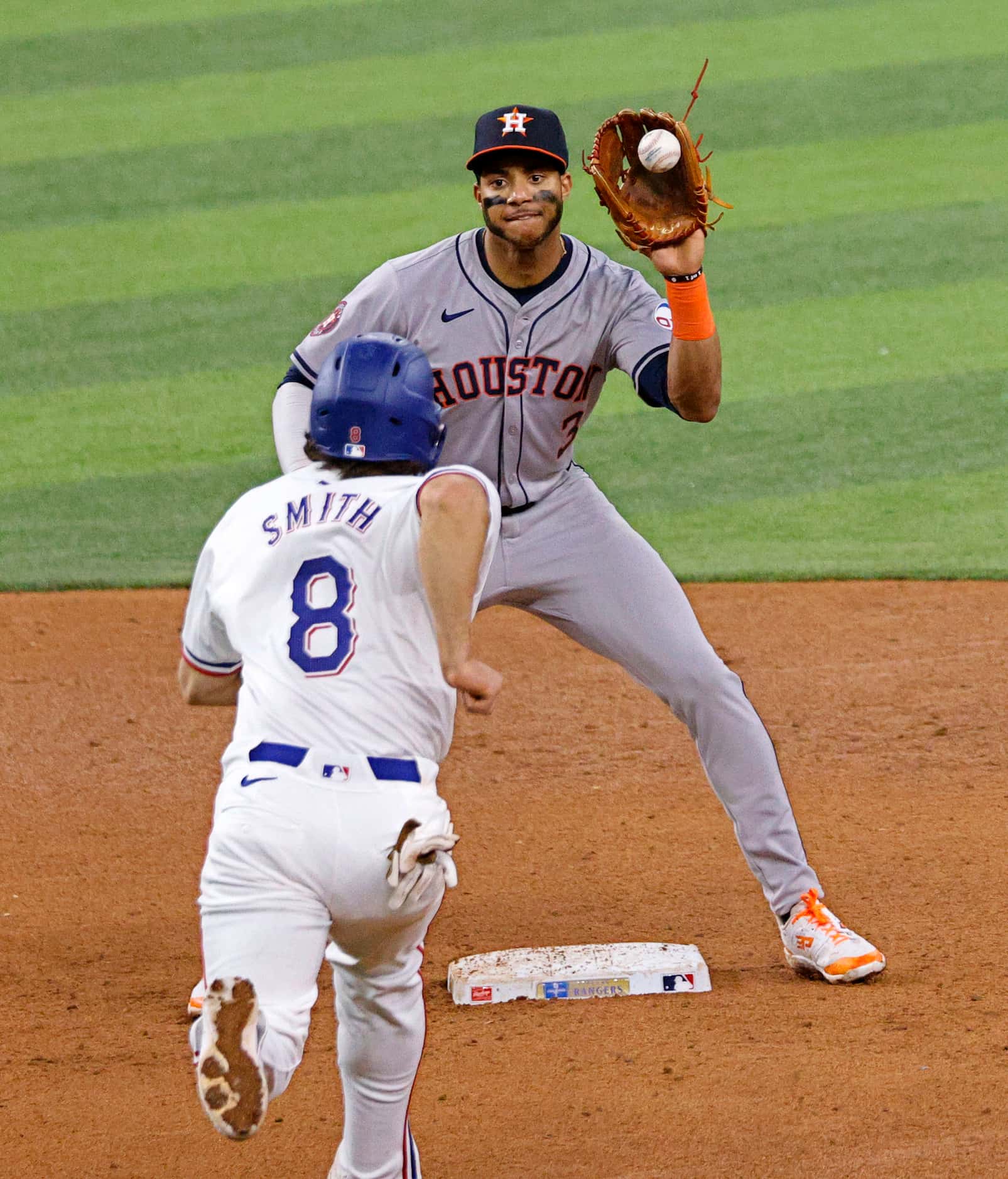 Houston Astros shortstop Jeremy Peña catches a ball as Texas Rangers third base Josh Smith...