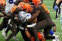 Dallas Cowboys quarterback Dak Prescott (4) is swarmed by the Cleveland Browns defense on a...