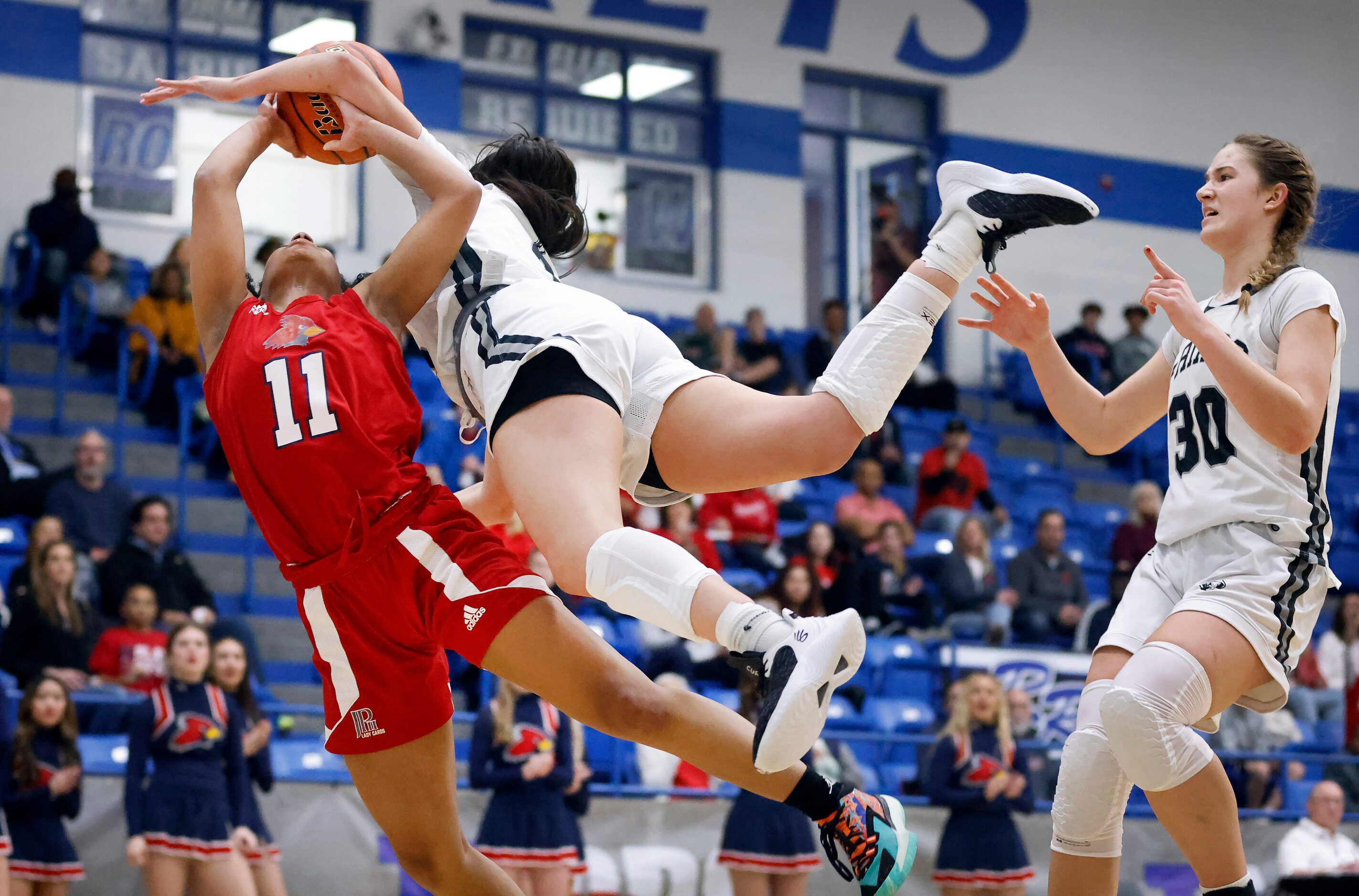 John Paul II guard Lydia Cook-Wiggins (11) is fouled hard by Bishop Lynch guard Natalie...