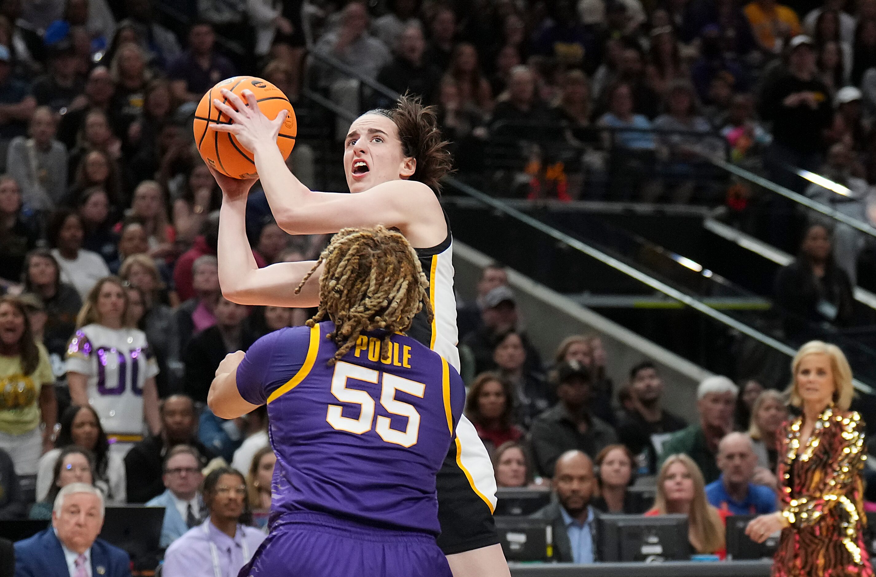 Iowa guard Caitlin Clark (22) shoots over LSU guard Kateri Poole (55) during the first half...