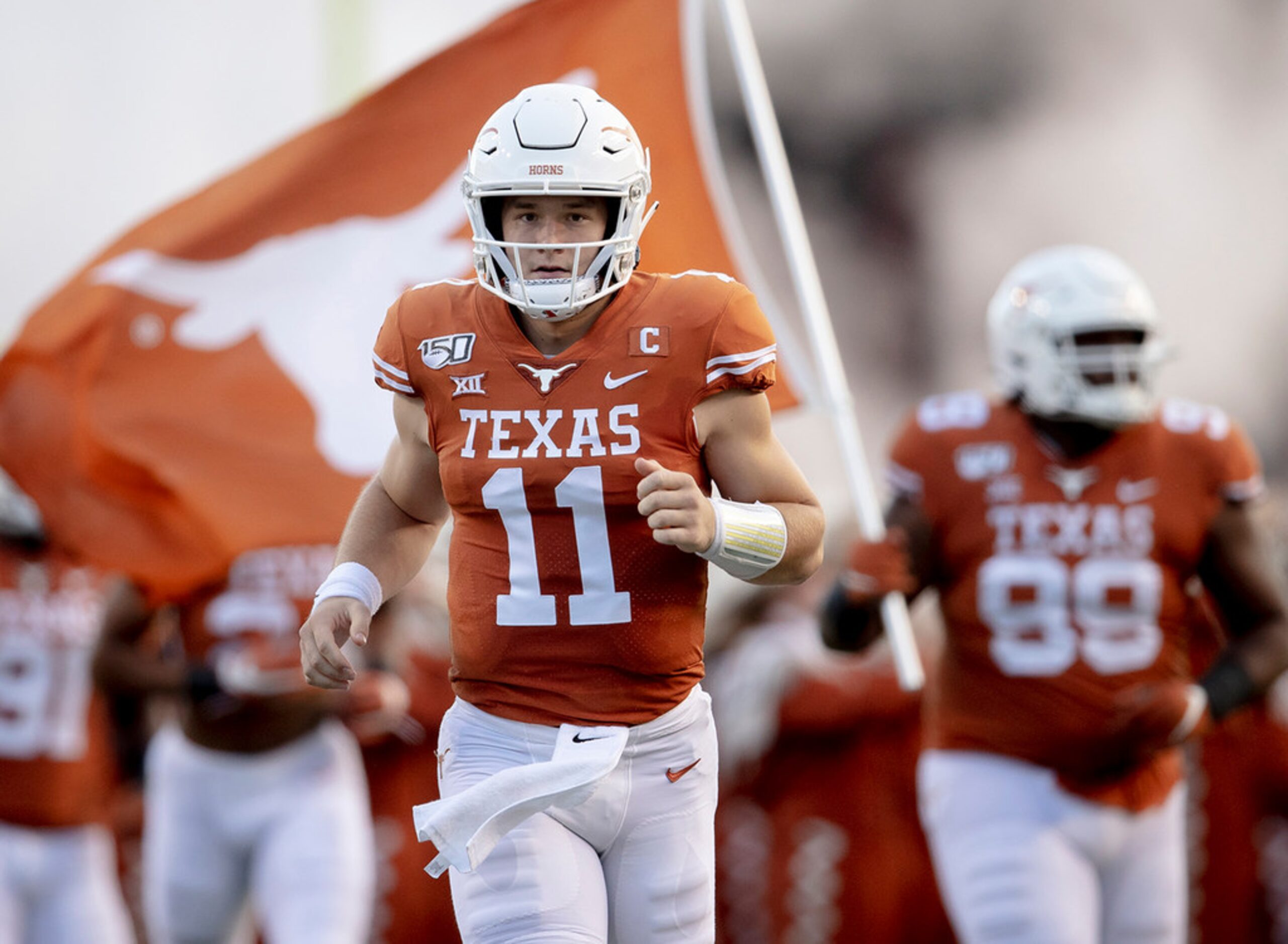 Texas quarterback Sam Ehlinger (11) runs onto the field before a game against Oklahoma State...