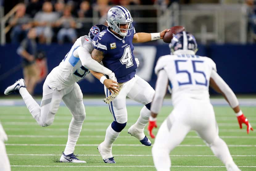 Dallas Cowboys quarterback Dak Prescott (4) is chased down by Tennessee Titans inside...