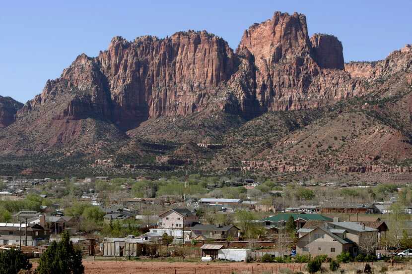  Hildale, Utah sits at the base of red rock cliff mountains with its sister city, Colorado...