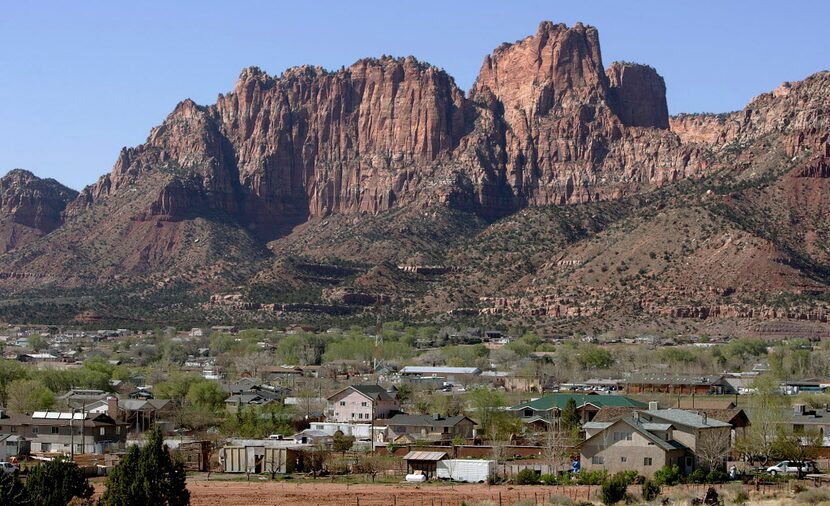  Hildale, Utah sits at the base of red rock cliff mountains with its sister city, Colorado...