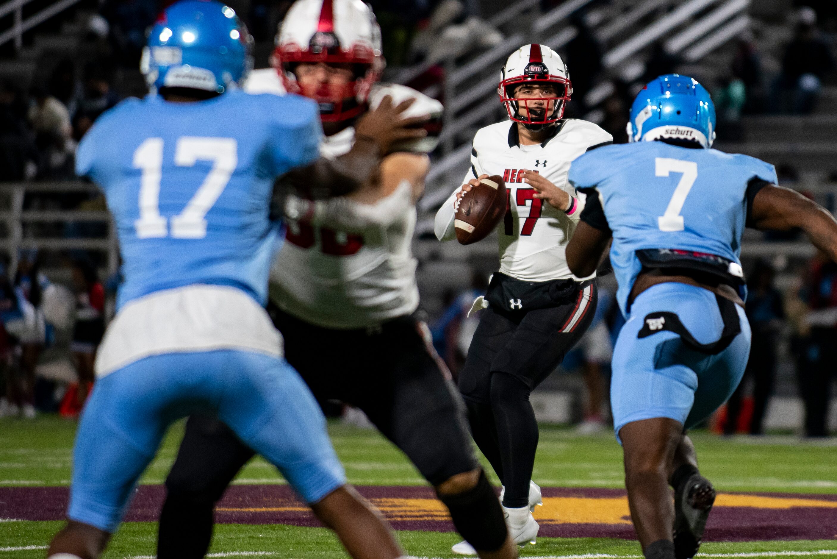 Heath senior Josh Hoover (17) drops back to pass the ball during a District 10-6A game...