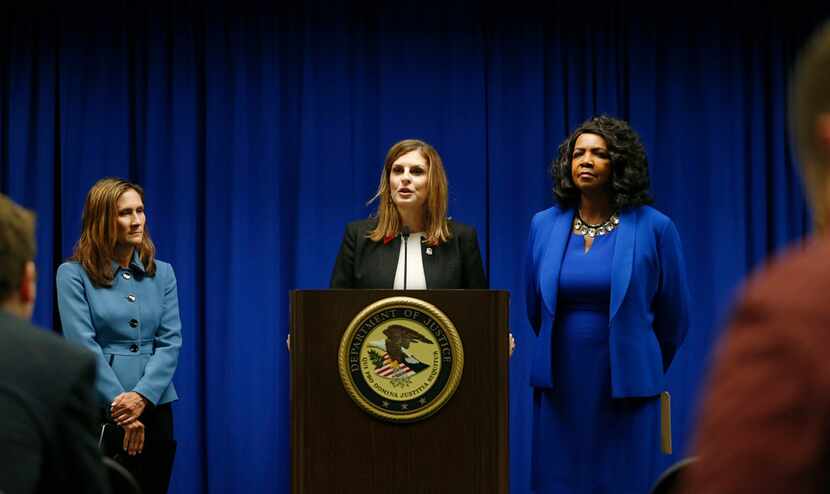 U.S. Attorney Erin Nealy Cox, center, holds a news conference on Friday, July 13, 2018 in...