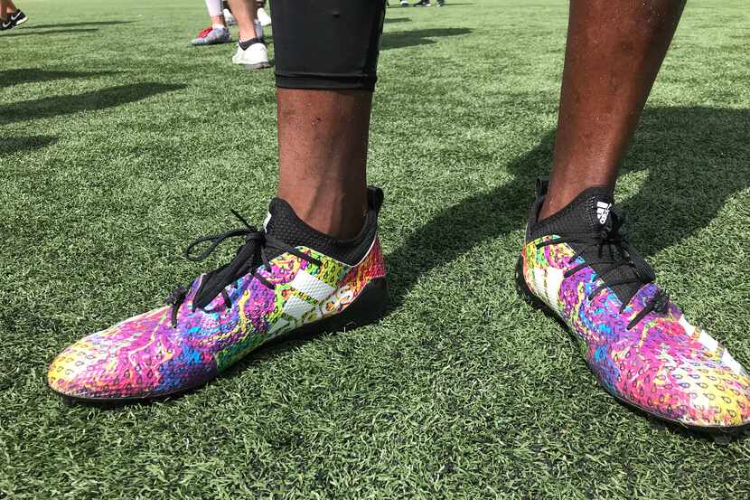Midlothian Heritage receiver Langston Anderson shows off the Adidas cleats each athlete...