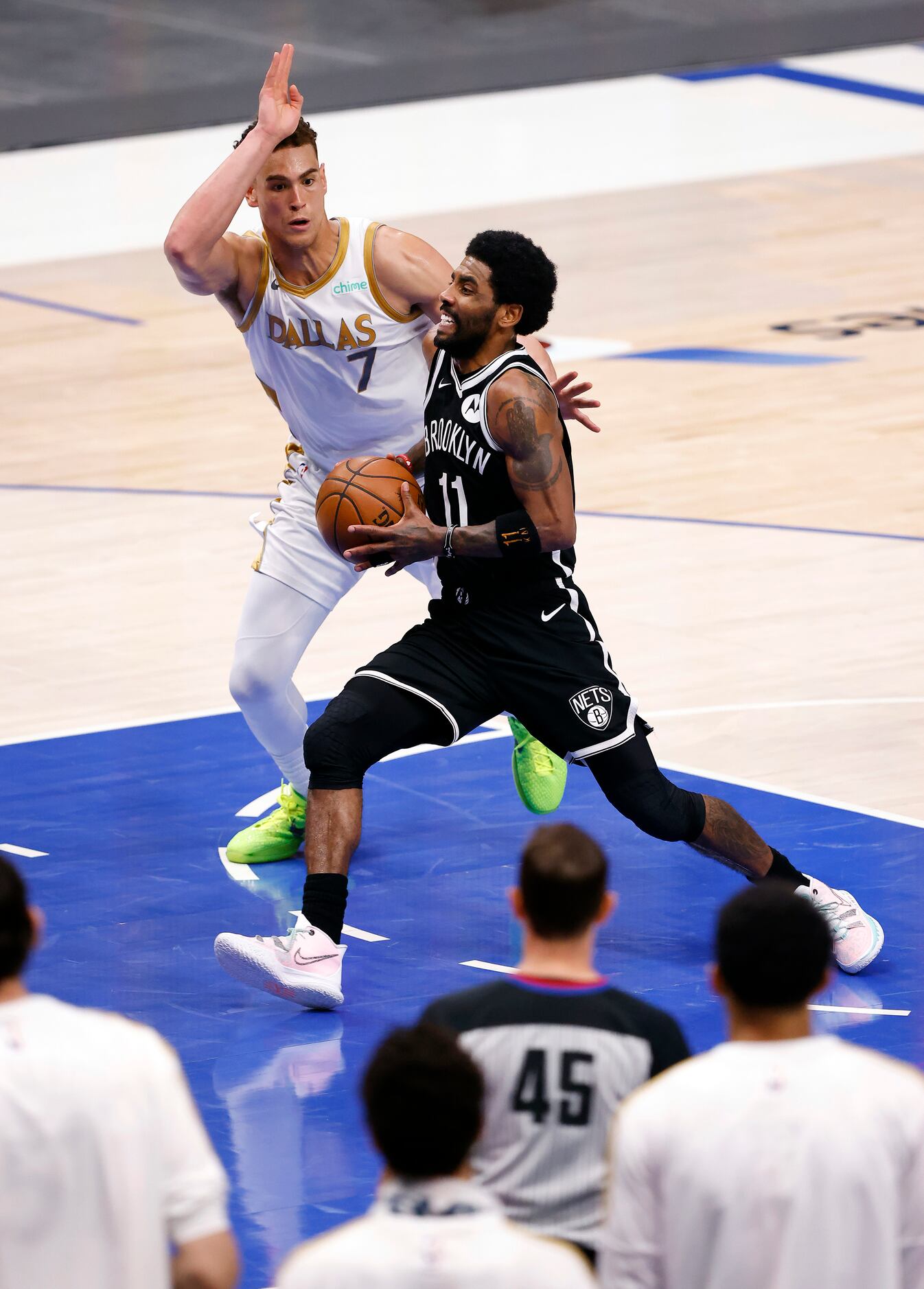 Brooklyn Nets guard Kyrie Irving (11) drives [ast Dallas Mavericks center Dwight Powell (7)...