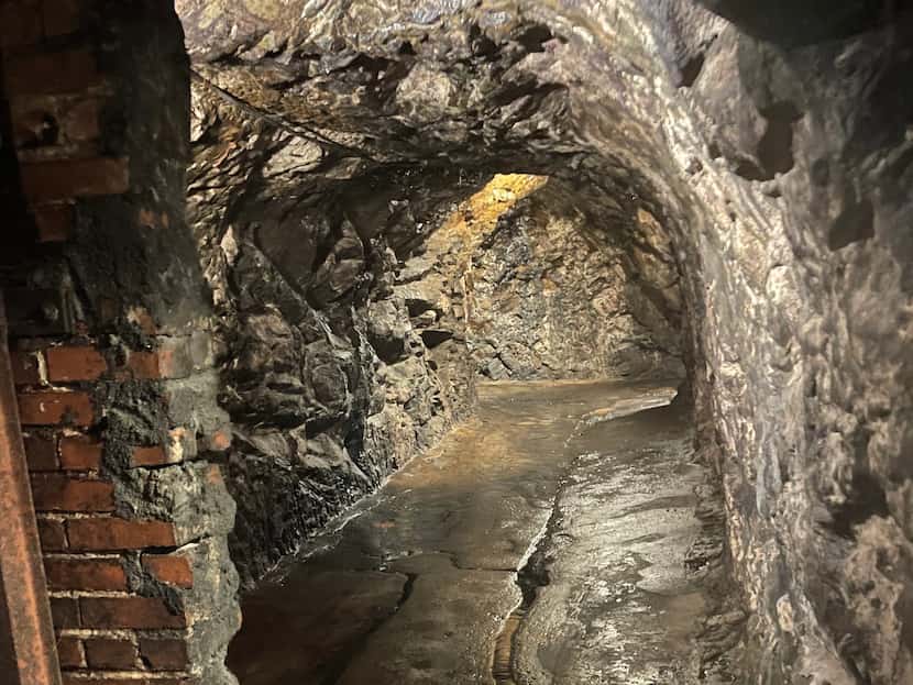 A portion of the Prohibition-era brick wall remains in the underground cave that once was...