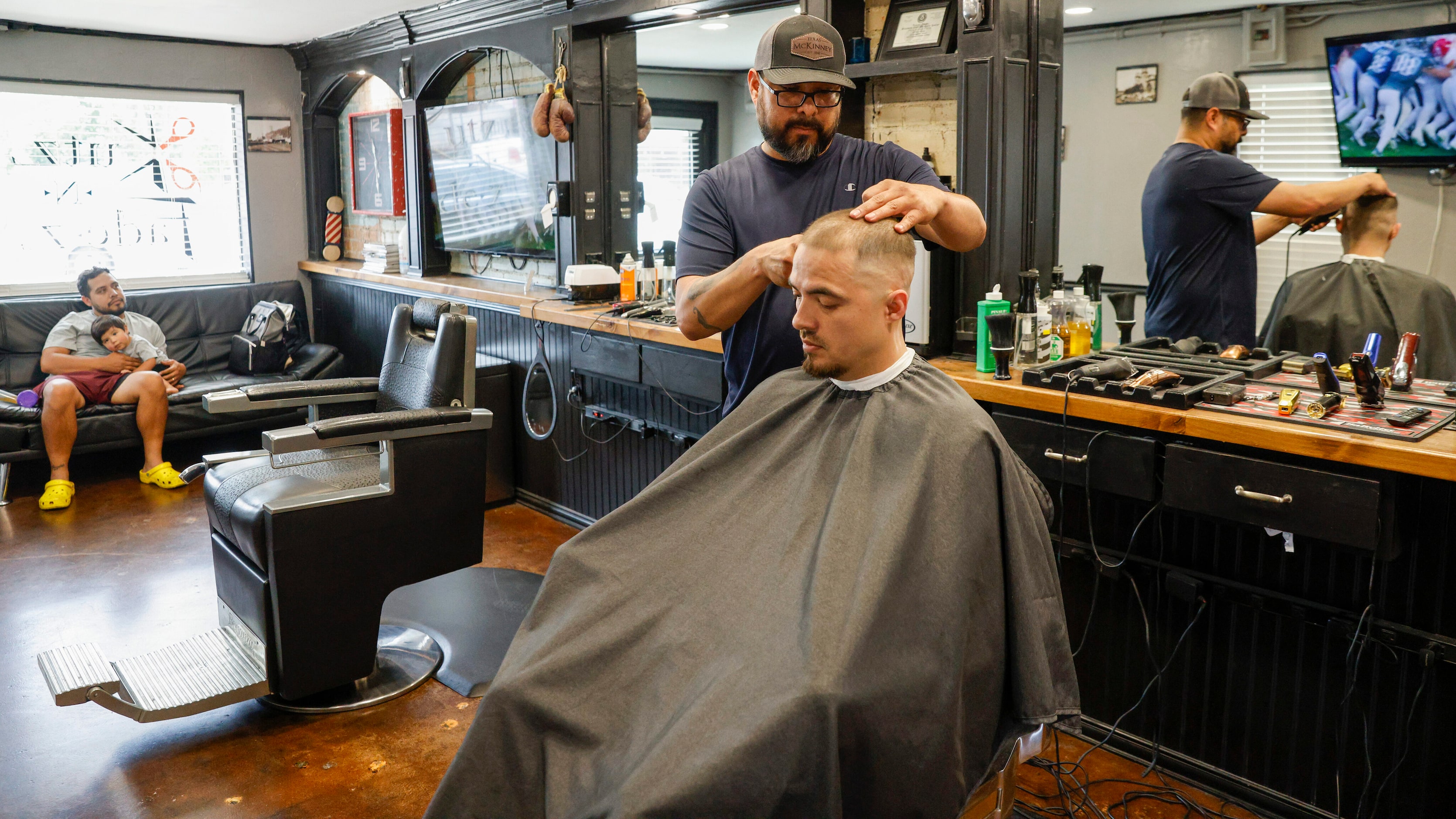 Owner Benjamin Salas cuts the hair of  at Kutz N Fadez on Wednesday, May 24, 2023, in...