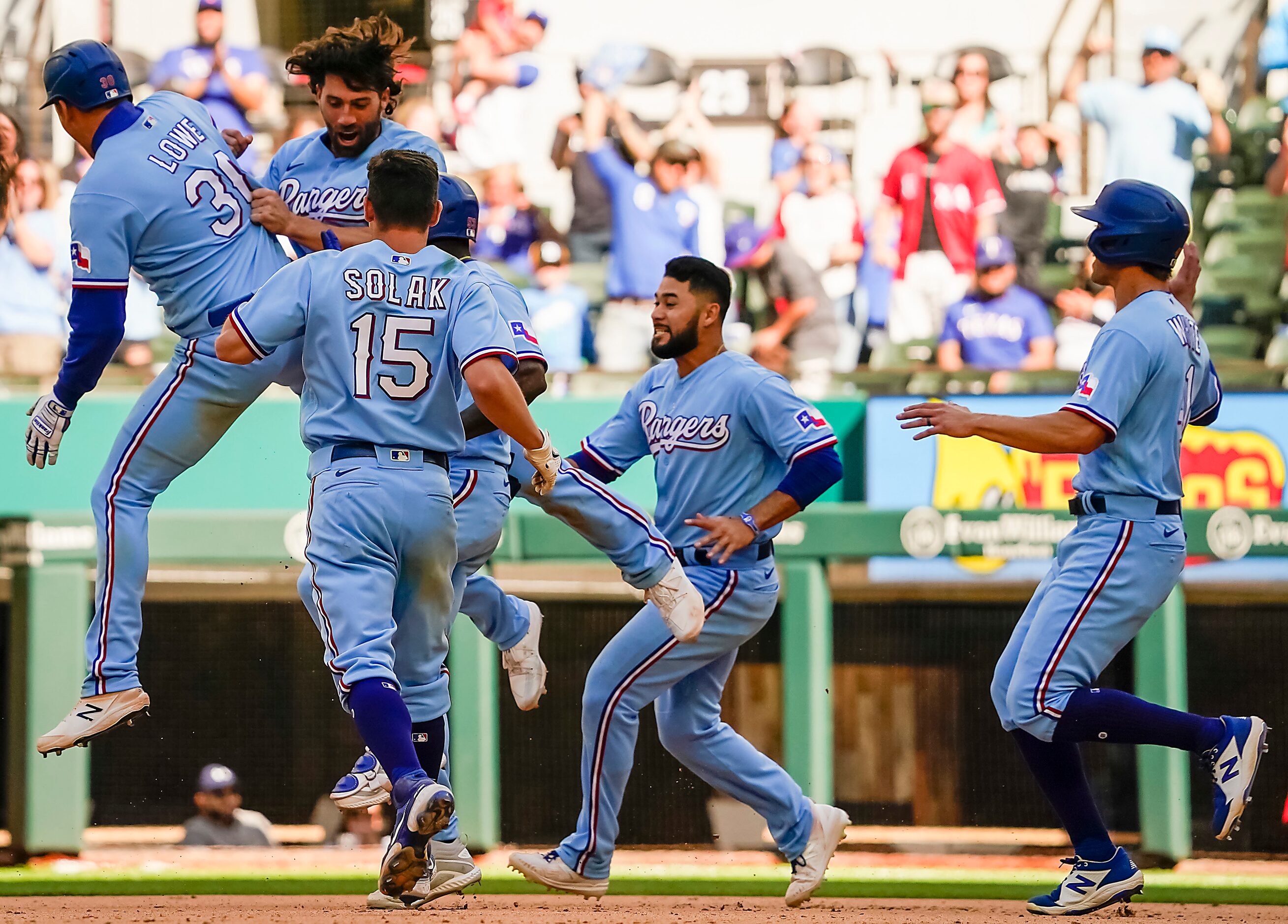 Texas Rangers first baseman Nate Lowe celebrates with infielder Charlie Culberson after...