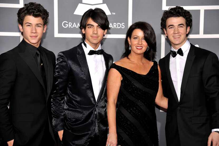 Musicians Nick Jonas, Joe Jonas and Kevin Jonas of The Jonas Brothers with mother mother...
